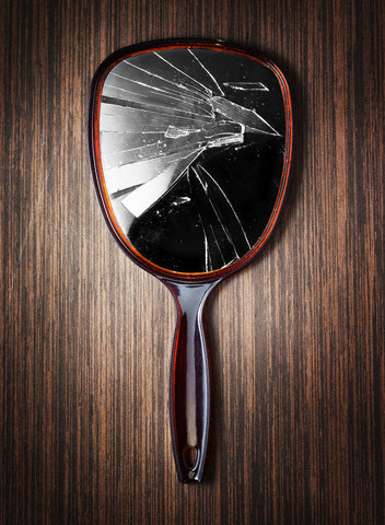 Broken hand mirror --- Image by © Sagel & Kranefeld/zefa/Corbis