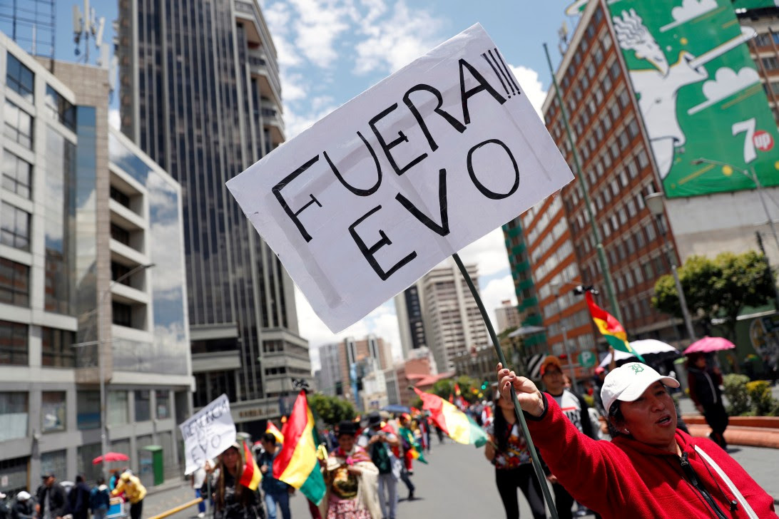 A woman holds a sign reading 'Evo out' during a protest against Bolivia's President Evo Morales in La Paz, Bolivia November 10, 2019. REUTERS/Carlos Garcia Rawlins