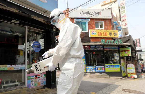 A quarantine worker sprays disinfectants at night spots of Itaewon neighborhood, following the coronavirus disease (COVID-19) outbreak, in Seoul, South Korea, May 11, 2020. Yonhap/via REUTERS ATTENTION EDITORS - THIS IMAGE HAS BEEN SUPPLIED BY A THIRD PARTY. SOUTH KOREA OUT. NO RESALES. NO ARCHIVE.