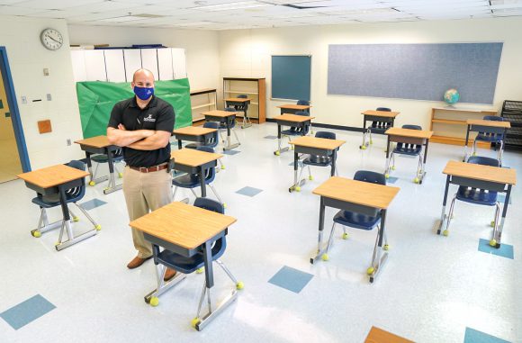 Fairfax County Public Schools assistant director of facilities management Todd Jones stands in a classroom where desks have been spaced to prevent the spread of the coronavirus disease (COVID-19) at Mantua Elementary School in Fairfax, Virginia, U.S., July 17, 2020. REUTERS/Kevin Lamarque
