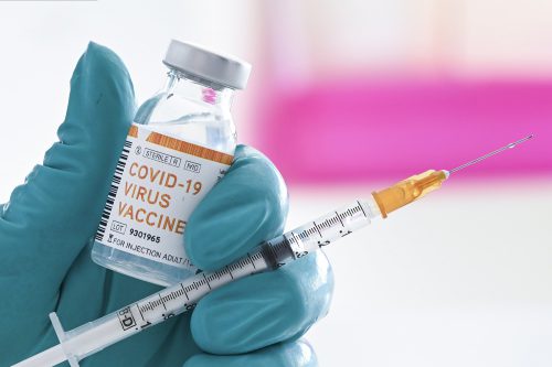 BRUSSELS, BELGIUM - JUNE 18 : In this illustration a doctor holds a syringe and a bottle labelled as the Covid-19 coronavirus vaccine. At least 8,000,202 cases of infection, including 435,176 deaths, were recorded in total, particularly in Europe, the continent most affected with 2,417,902 cases (188,085 deaths) and in the United States, which has the highest number of cases (2,110,182) and deaths (116,081). There are about a hundred projects for vaccines against Covid-19, of which about ten are in the clinical trial phase. Pictured on June 18, 2020 in Brussels, Belgium, 18/06/2020 ( Photo by Vincent Kalut / Photonews via Getty Images)